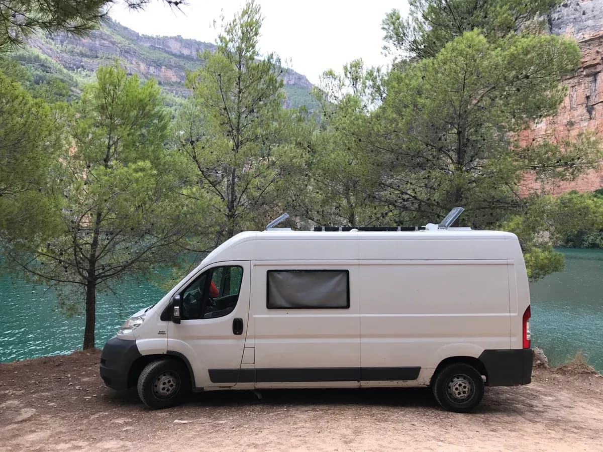 The camper parked beside a river